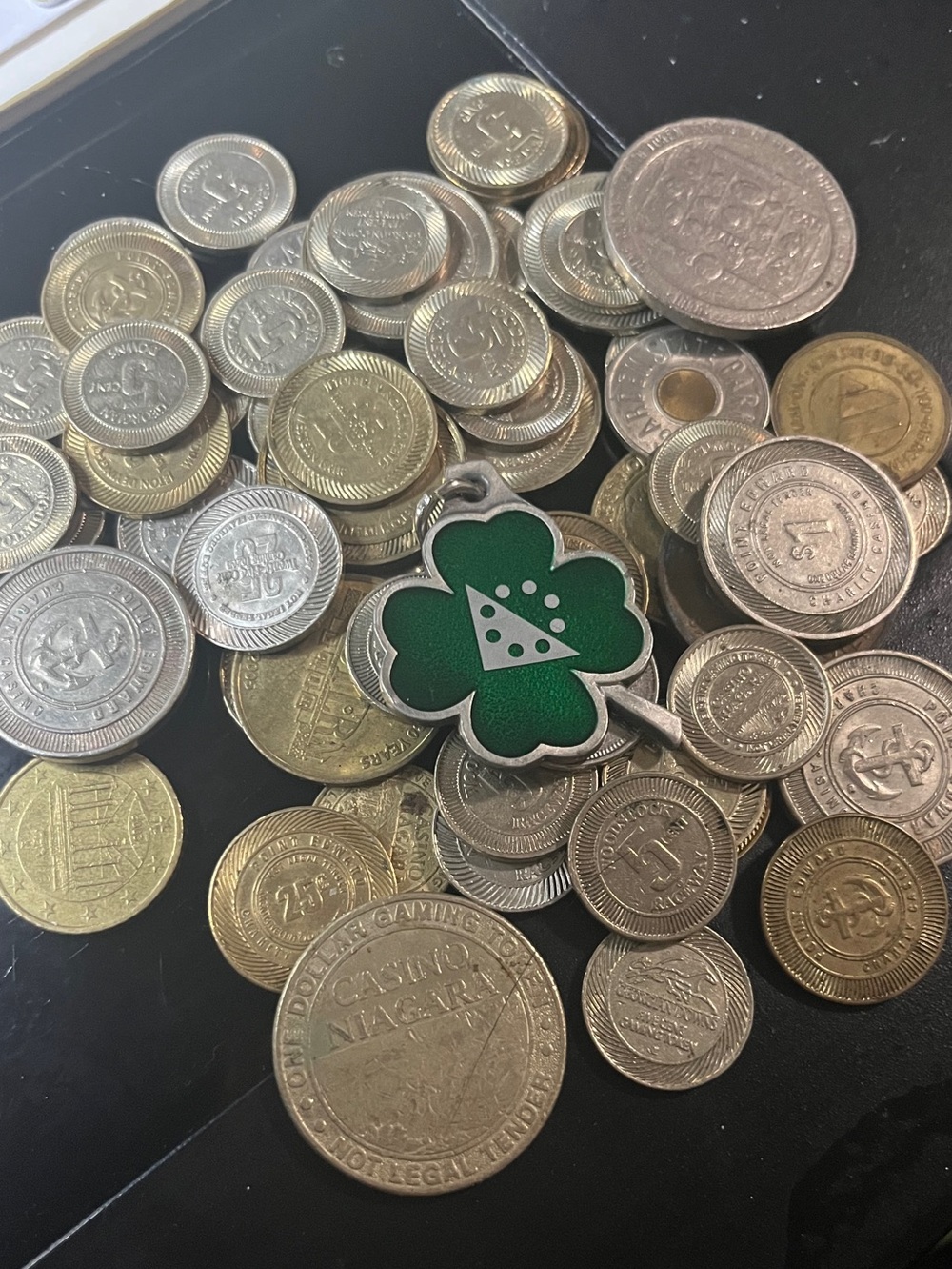 Casino vintage coins from many different casinos and OLG 4 leaf clover key tag